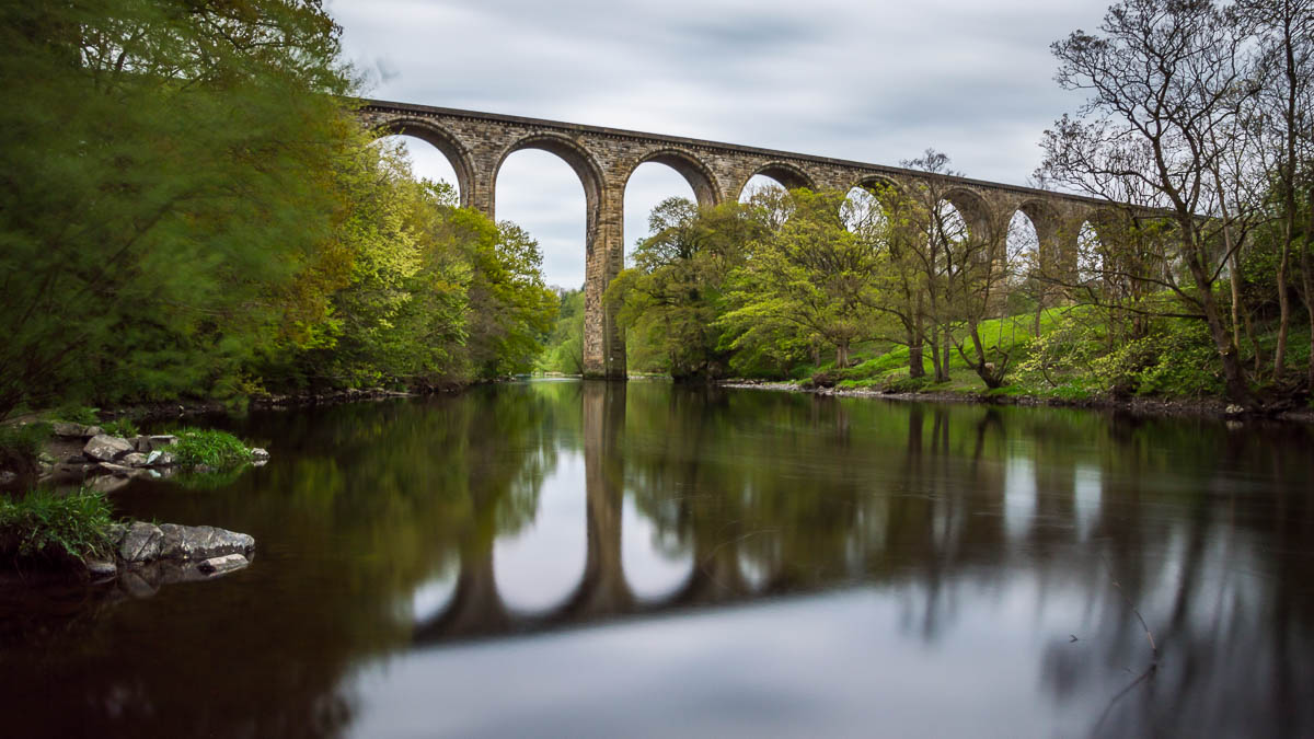Cefn Viaduct with its reflection below in the river. 