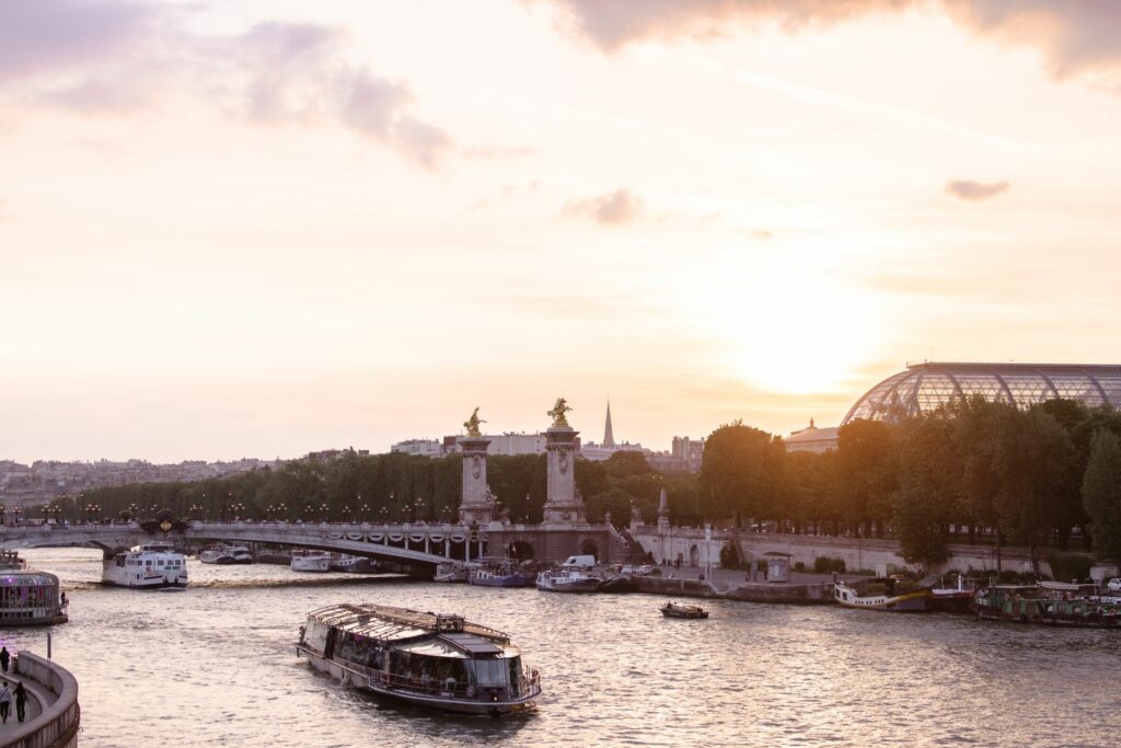 Scenic view of Paris with the Seine River and iconic architecture during sunset.
