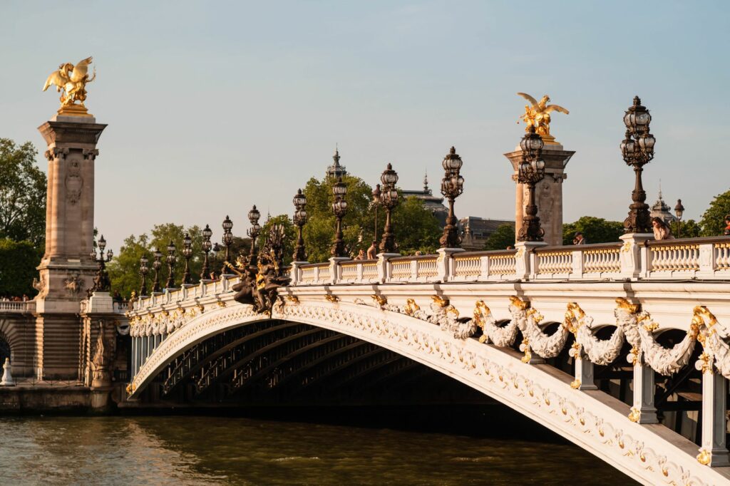 Golden statues adorn the iconic Pont Alexandre III bridge over the Seine in Paris, France.