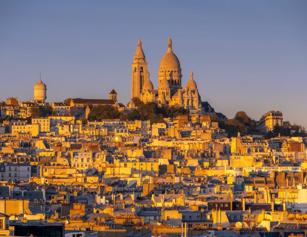 Beautiful evening light on Montmartre and Sacré-Cœur Basilica in Paris at sunset.