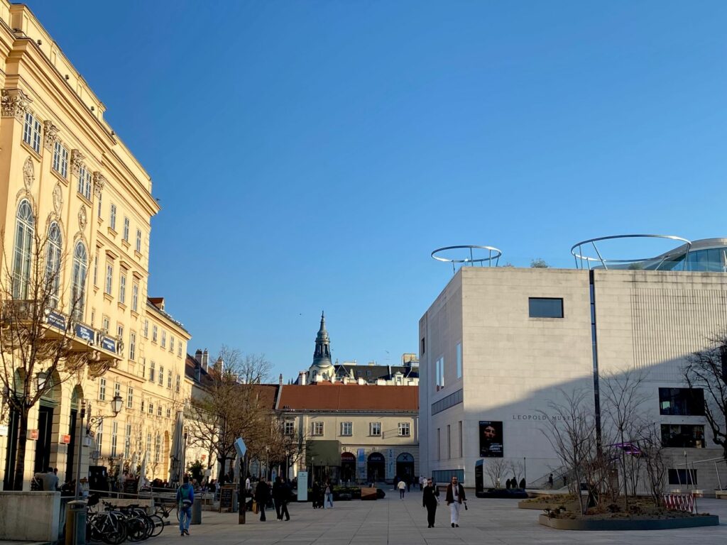 View of Leopold Museum and historic architecture in Vienna with clear blue sky.