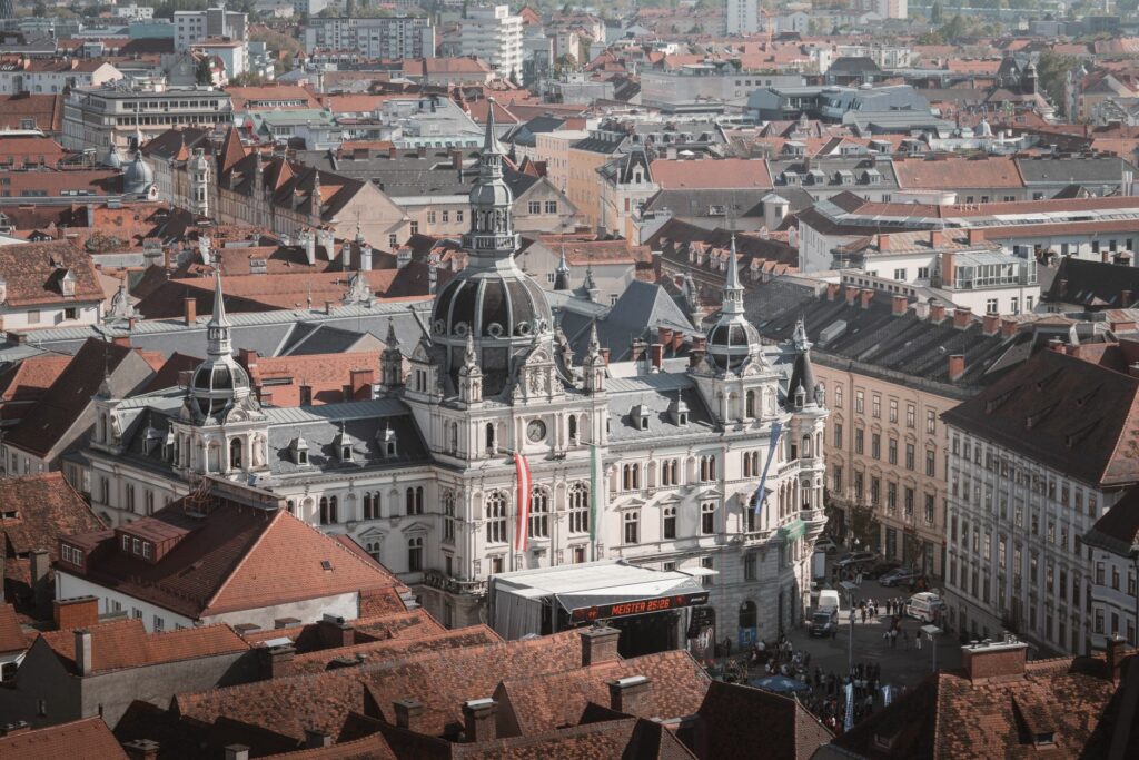 Captivating aerial view of Graz City Hall with surrounding red rooftops, Styria, Austria.