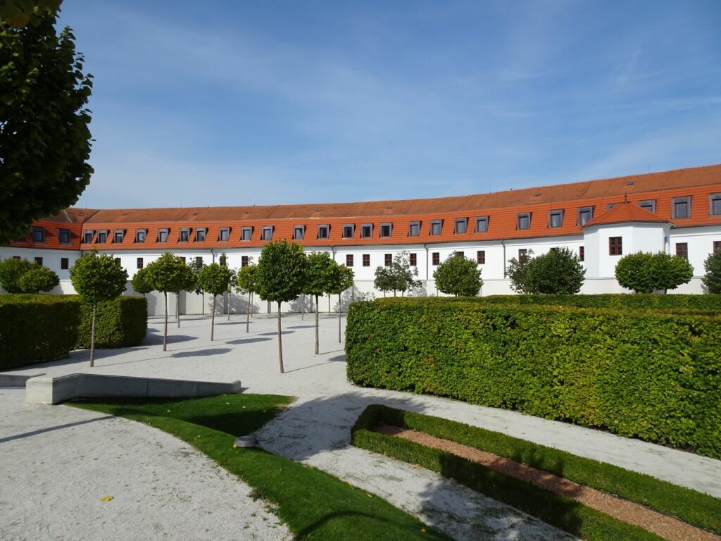Explore the neatly trimmed gardens of Bratislava Castle, showcasing elegant European architecture and vibrant greenery.