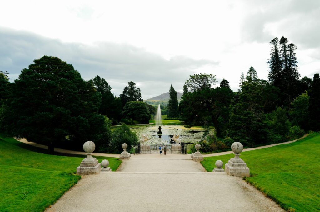 A picturesque garden landscape with a central fountain and lush greenery, perfect for nature lovers.