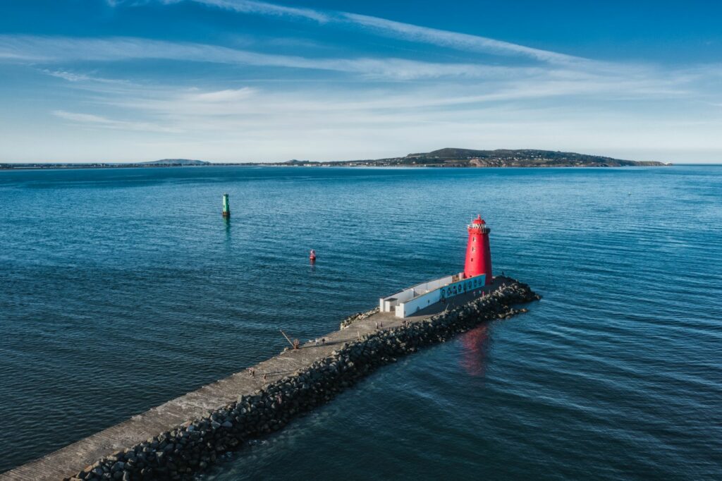 Scenic aerial shot of Poolbeg Lighthouse on a sunny day, Dublin Bay, Ireland.