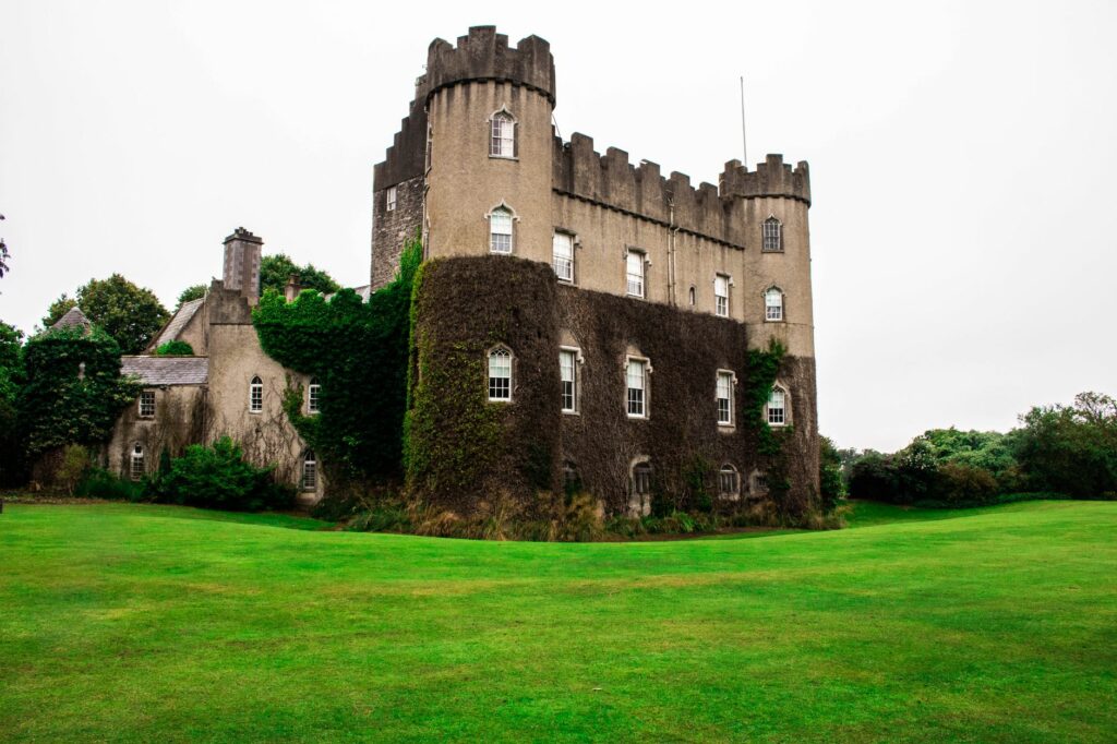 Picturesque view of the ancient Gothic castle in Malahide, surrounded by lush green lawns and ivy-clad walls.