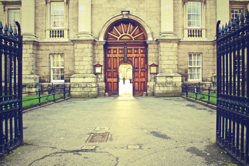 Elegant entrance of a historic stone building with a grand wooden door. Classic architecture.