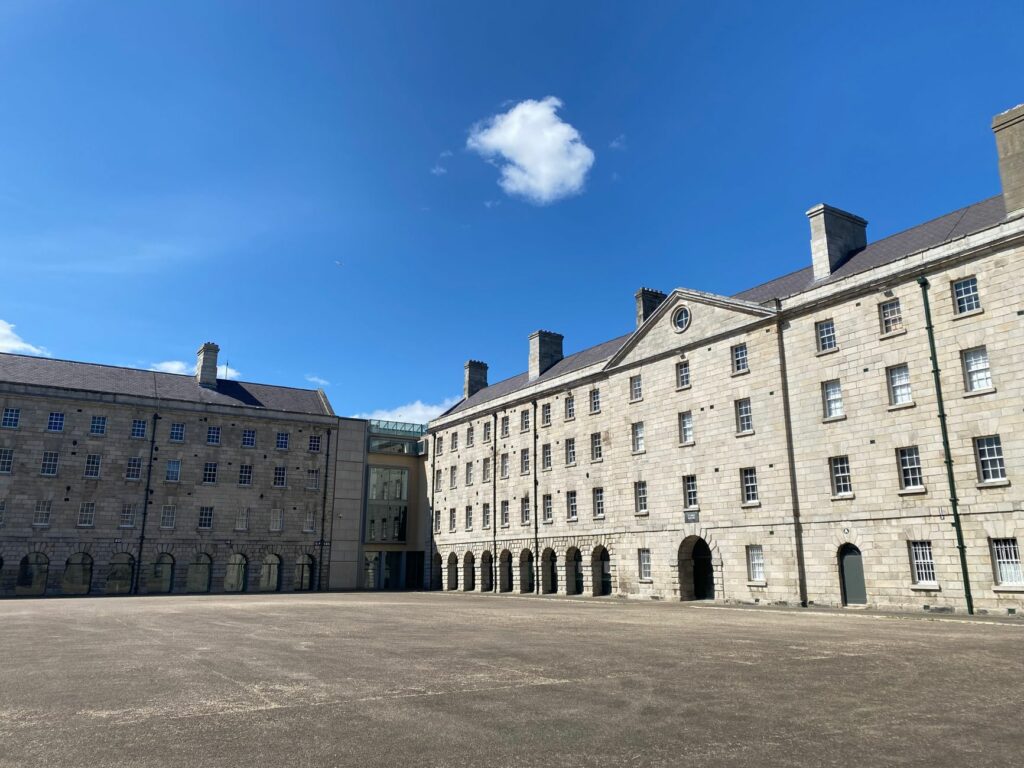 Empty courtyard of a historic building under a bright blue sky in Dublin, Ireland.