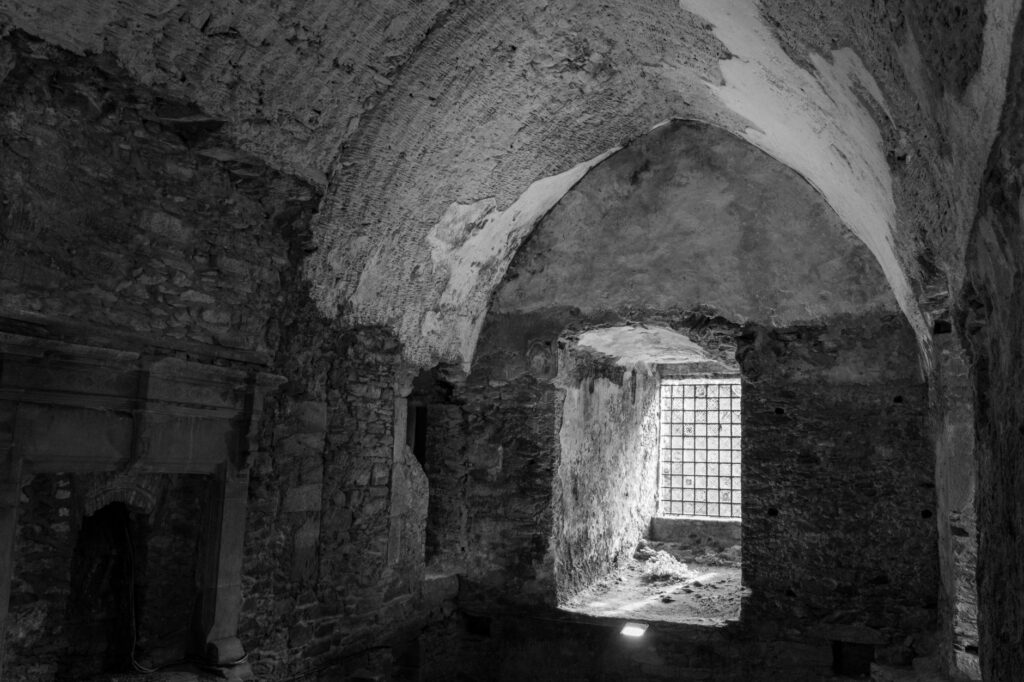Black and white photo of ancient stone interior in Cork, Ireland.