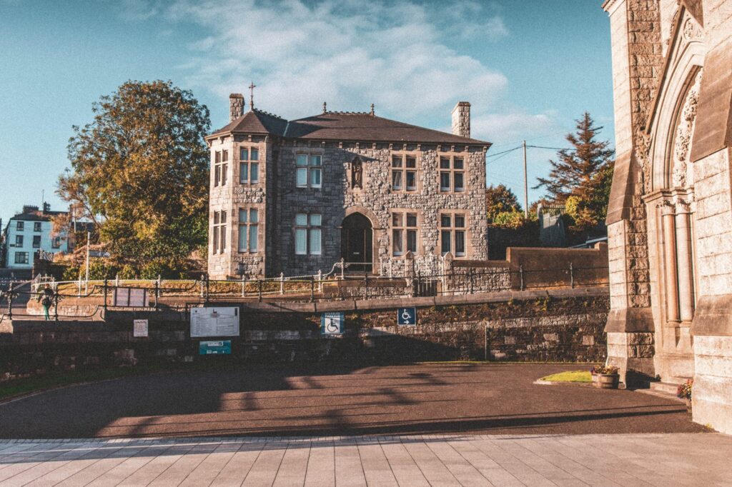 Old stone mansion in the scenic town of Cobh, County Cork, surrounded by historic architecture.