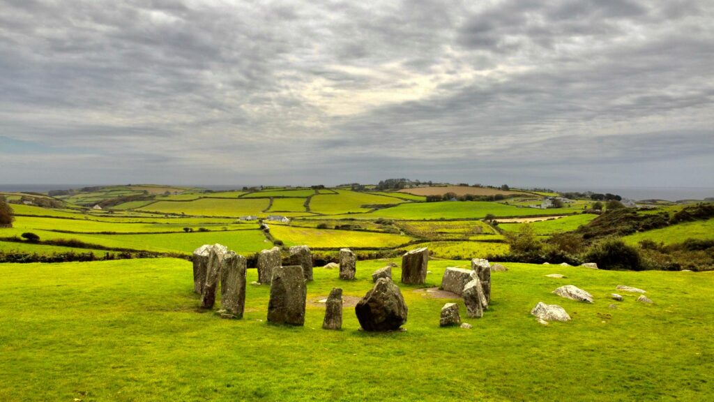 Scenic view of Drombeg Stone Circle with lush fields in Ireland.