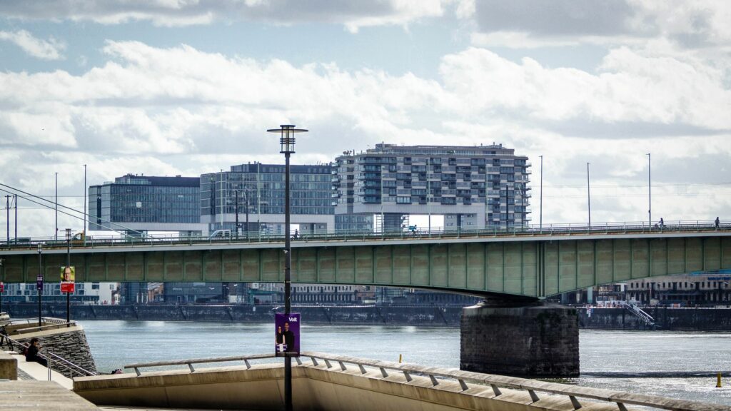 Modern bridge crossing the Rhine in Cologne, showcasing urban architecture and cityscape.