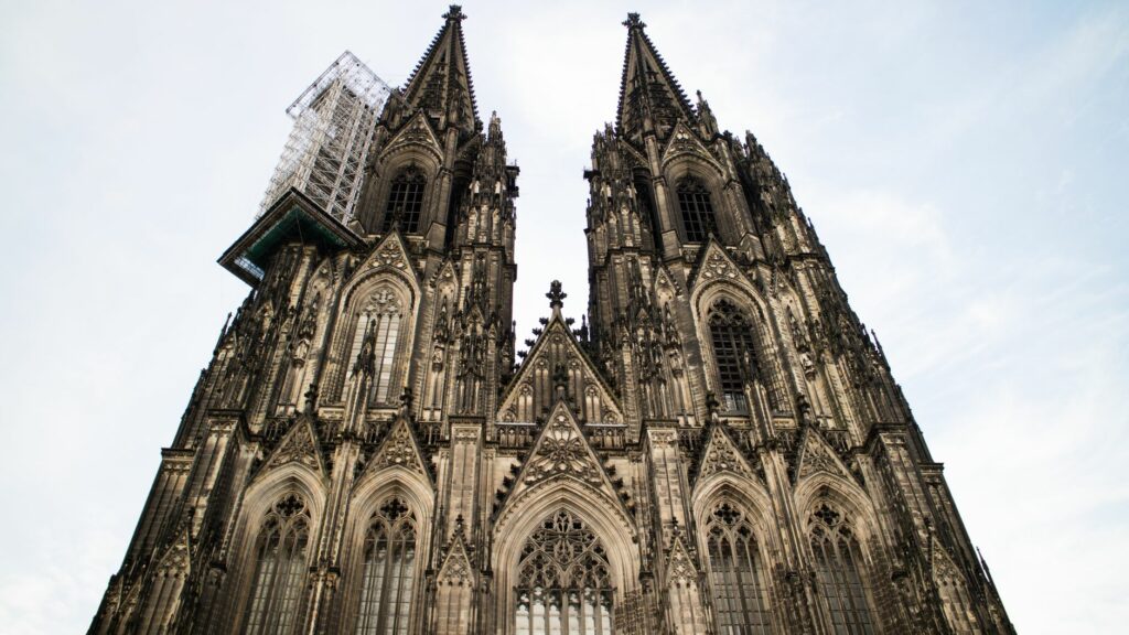 Stunning Gothic architecture of Cologne Cathedral in Germany against a clear sky.