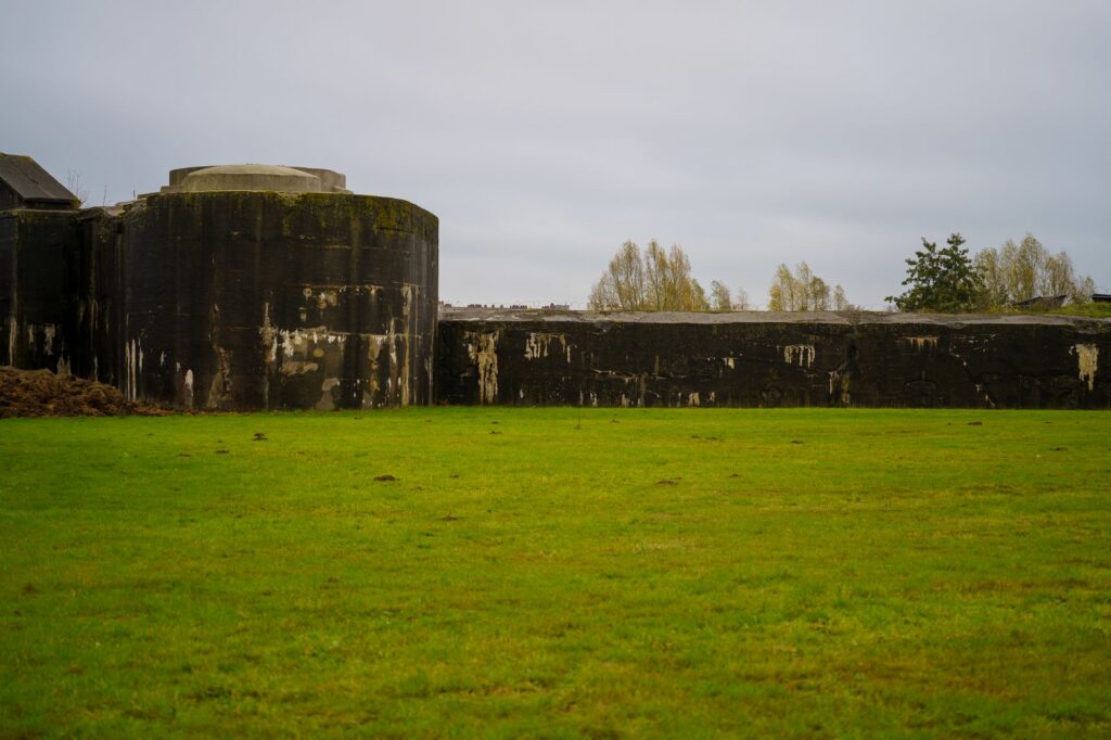 Stone fortification surrounded by green grass in Willebroek, Belgium, showcasing historical architecture.
