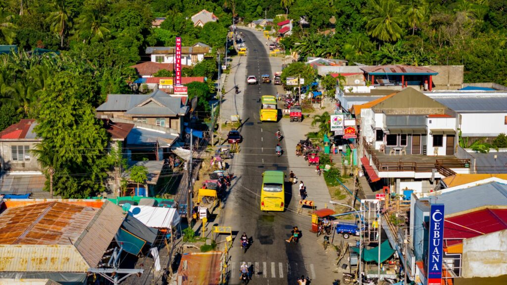 A vibrant aerial view of Bacong, Philippines, showcasing busy streets and lush greenery.