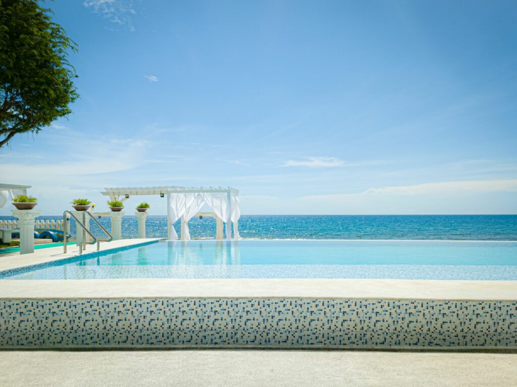 Stunning infinity pool at a luxury resort overlooking the ocean, perfect for relaxation and vacations.