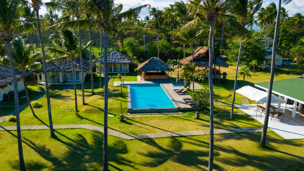 Stunning aerial view of a tropical resort with a pool and lush greenery in Bacong, Central Visayas.