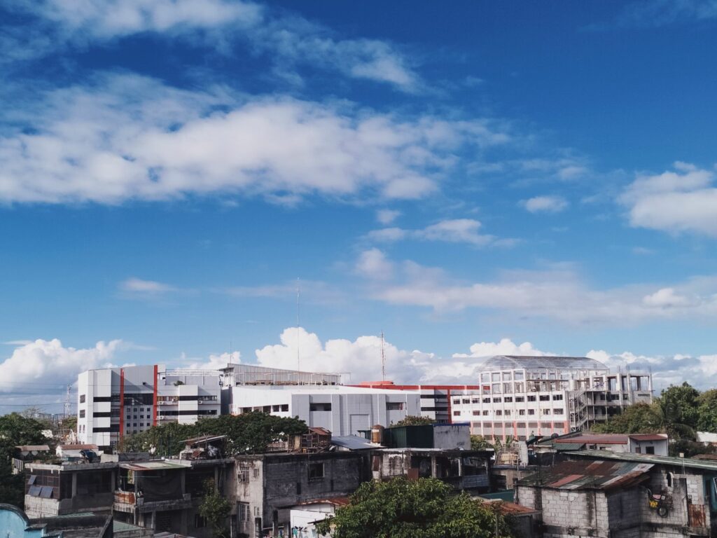 Skyline of Taguig, Manila showcasing modern buildings against a bright blue sky.