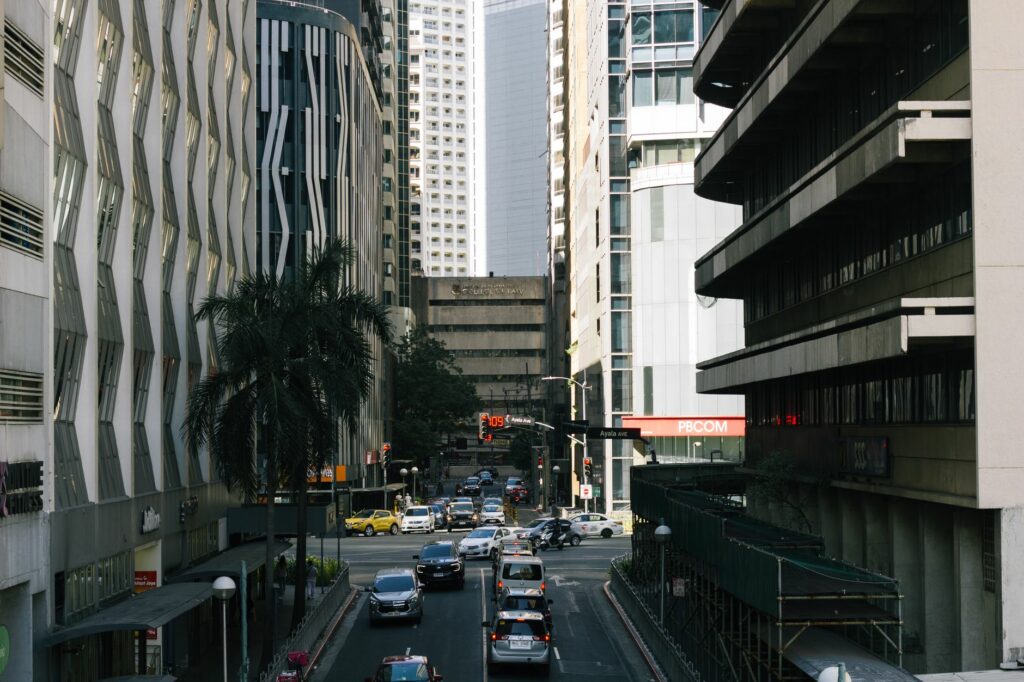 View of traffic and skyscrapers on Ayala Avenue, Manila's bustling business district.