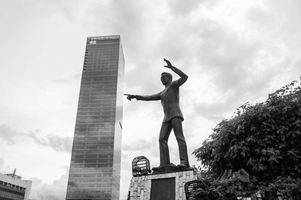 Black and white photo of a statue in front of a skyscraper in Pasig, Metro Manila, Philippines.