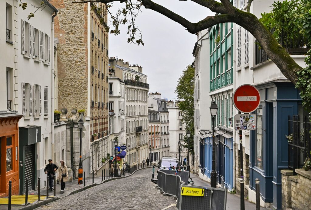 Explore the charming streets of Montmartre, Paris with its classic European architecture and vibrant city life.
