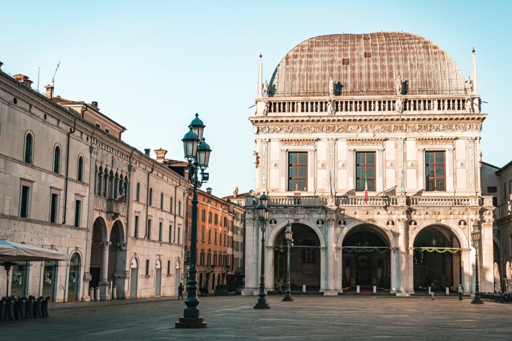 Beautiful historic building in Italian plaza during sunrise with warm light.