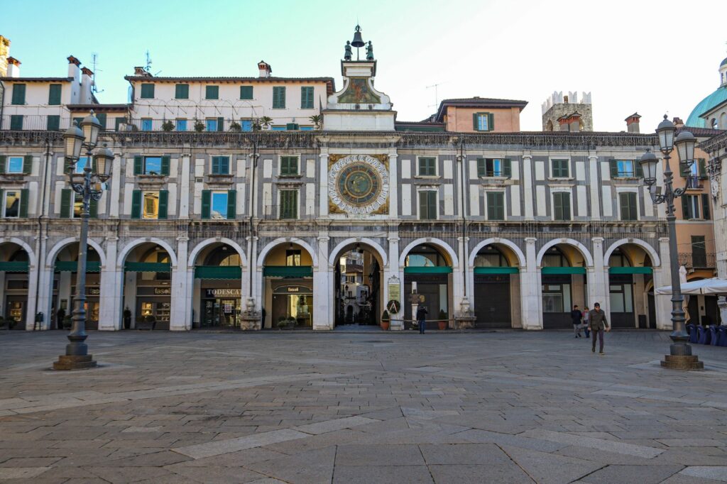 View of the Clock Tower in Piazza della Loggia, Brescia, Italy, showcasing Renaissance architecture.