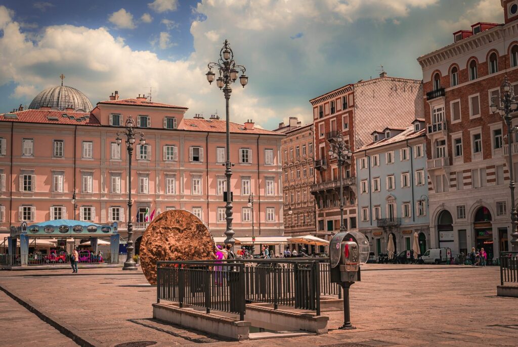 A lively Italian piazza featuring historic architecture and vibrant street scene on a sunny day.