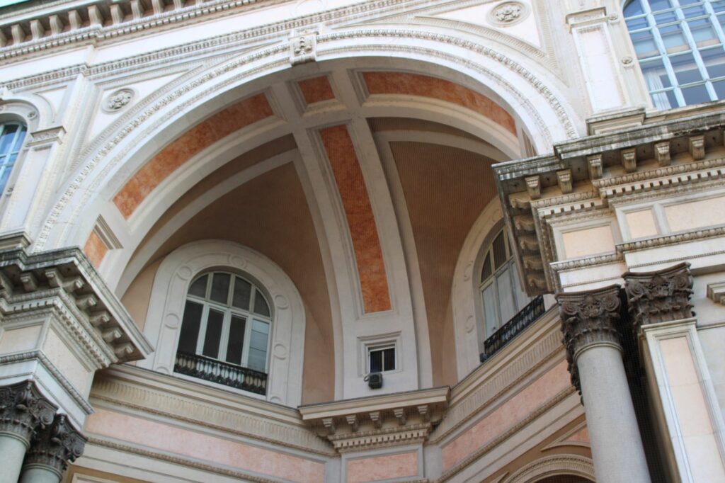 Explore the intricate architecture of Galleria Vittorio Emanuele in Milan, showcasing elegant arches and classic design.