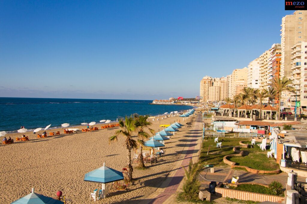 Scenic view of the Alexandria coastline with beach huts and Mediterranean Sea.
