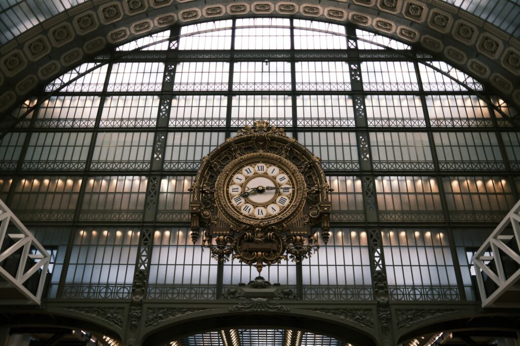 Interior view of the grand clock in the Musée d'Orsay, Paris, showcasing its ornate design and architectural beauty.