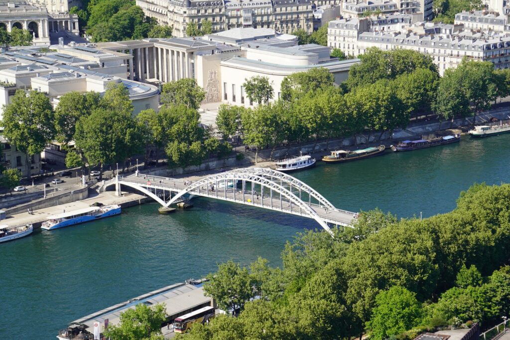Scenic aerial view of the Seine River and bridge in Paris, highlighting the city's architecture.