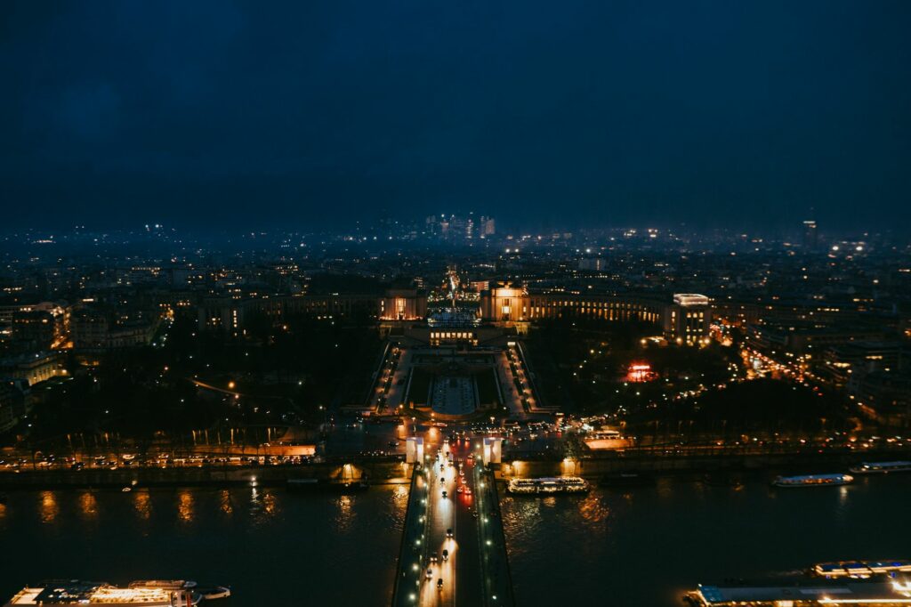Stunning nighttime aerial cityscape of Paris highlighting iconic landmarks.